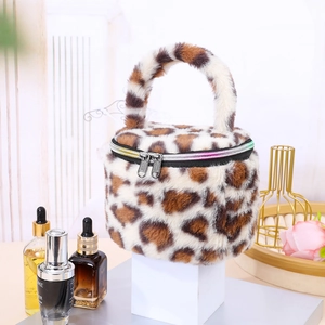 Detailed view of leopard print plush cylindrical makeup bag with rainbow zipper.