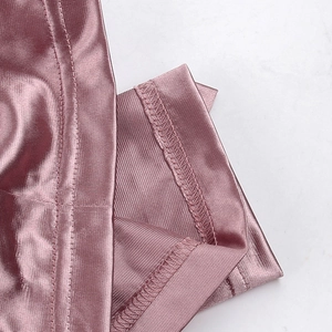Detail of pearly pink dress showing metallic luster fabric and precise overlock stitching