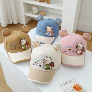 Detail of four colorful kids baseball caps with 3D bear ears and cartoon patches