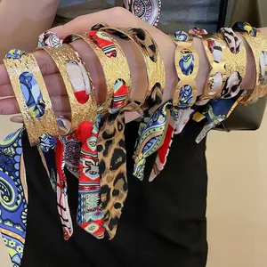 French retro open cuff bracelet with woven floral silk scarf on gold hollow metal