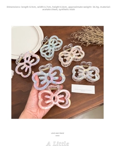 Detail view of pearlescent hollow bow hair claw clip with specific dimensions and spring
