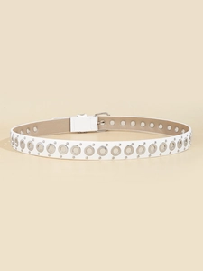 Close-up of a white leather punk belt with silver metal rings and rivets on a beige surface