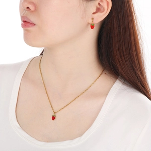 Sweet red strawberry pendant necklace and earrings set in gold finish on female model