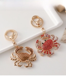 Detail of crystal-encrusted and hollow crab keychains with lobster clasp and ring