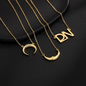 18K gold plated necklaces featuring zircon crescent, moon face, and letter pendants