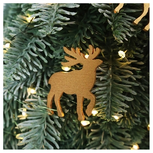 Close-up of a natural wooden reindeer ornament hanging on a festive Christmas tree branch