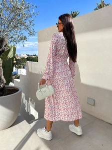 Detail of white floral V-neck midi dress with elastic waist and lantern sleeves