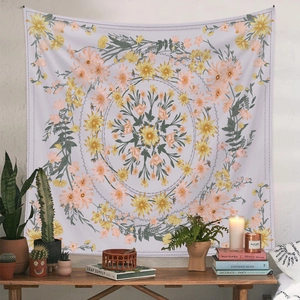 Close-up of bohemian floral tapestry as cozy home decor with plants and candles