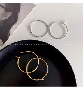 Minimalist large hoop earrings in gold and silver finish with mirrored metal luster