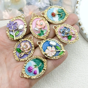 Set of seven vintage gold oval flower charms with colorful enamel and faux pearls