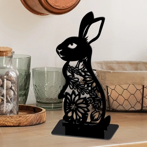 Detail of hollowed-out black bunny silhouette ornament on a modern kitchen countertop