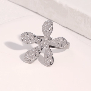 Macro view of silver flower ring featuring artistic hammered texture on stone base