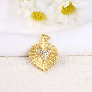 Detail of a gold plated heart cross pendant featuring sparkling zircon stone inlay