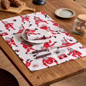 Christmas Santa Claus printed linen napkins and placemats on a rustic wooden dining table