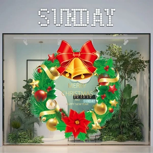 Detail showing Christmas wreath window sticker with red bow, gold bells and Merry Christmas text