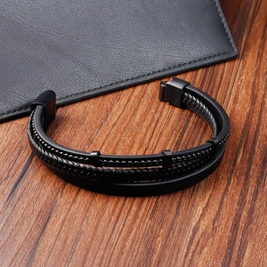 Close-up of black multilayer braided leather bracelet with stainless steel metal accents