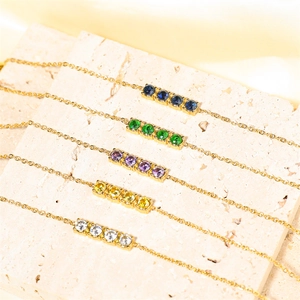Minimalist gold titanium steel bracelets with colorful blue, green, and purple gemstones