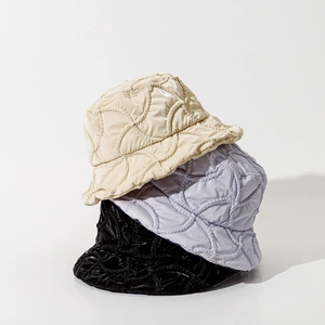 Padded wavy quilted bucket hats in cream, lilac and black colors with glossy finish