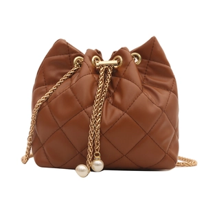 Brown quilted leather bucket bag with gold chain strap and pearl charm for women