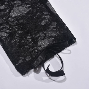 Detail of black lace long sleeve with elegant ribbon tie on delicate mesh fabric