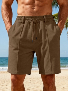 Detail of men's brown outdoor shorts featuring an adjustable drawstring and textured fabric
