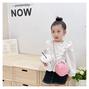 Pink quilted round mini crossbody bag styled with a white ruffle shirt and denim skirt