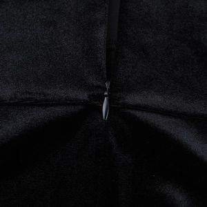 Macro shot of invisible zipper detail on black velvet strapless dress with smooth texture