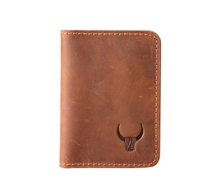 Macro shot of brown genuine leather card holder with stitched edges and embossed bull logo