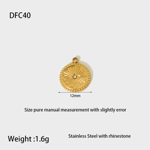 Detailed view of a 12mm gold stainless steel charm with rhinestones and eye motif