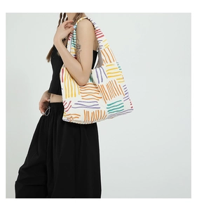 Detail of white corduroy tote bag with colorful geometric lines and large capacity
