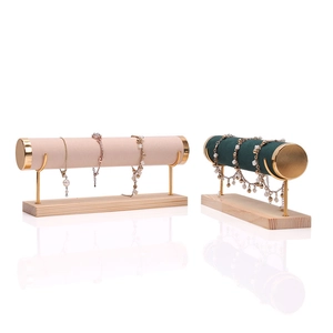 Pink and dark green velvet jewelry bracelet display stands with gold metal and wood base