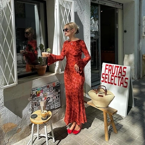 Detail of red floral maxi dress with long sleeves and elegant slim-fit waist design