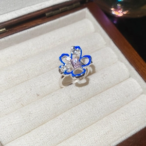 Vista dettagliata dell'anello a fiore in argento con smalto blu e gemma rosa