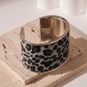 Detail of wide leopard print bangle with furry texture on silver metal base