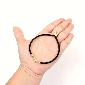 Classic black braided rope bracelet featuring a gold letter A pendant with rabbit ear clasp