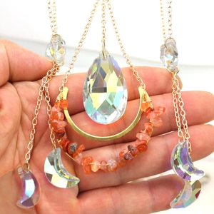 Detailed shot of golden moon suncatcher with AB crystal prisms and orange stones