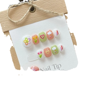 Cute hand-painted press-on nails featuring floral tulip and heart patterns in pastel tones