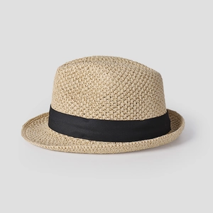 Detailed view of the fine beige woven texture and wide black satin ribbon on the fedora hat