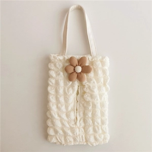 Detail of white bubble fabric tissue box holder with a 3D caramel flower accessory
