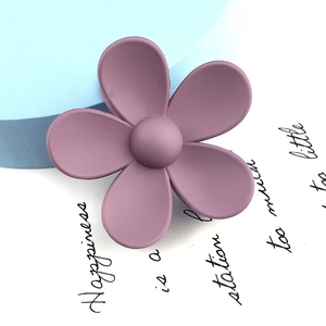 Macro shot of large matte purple flower hair claw clip with elegant five-petal design