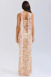 Vue arrière d'une robe fleurie beige élégante avec détails plissés et rubans d'épaule