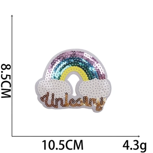 Close-up of rainbow cloud sequin patch with Unicorn text measuring 10.5cm by 8.5cm