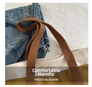 Close-up of contrast stitching canvas tote bag with thick brown reinforced handles