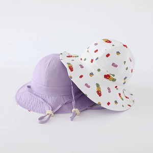 Detail of kids' reversible bucket hats with cartoon prints and adjustable chin straps