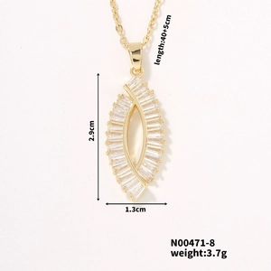 Detailed close-up of a gold hollow oval pendant with baguette cubic zirconia stones