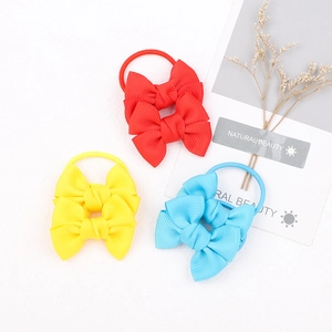 Three colorful grosgrain ribbon bow hair ties for girls in red, yellow, and sky blue