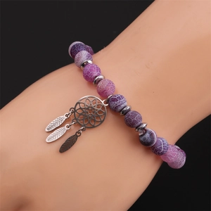 Detailed shot of purple agate bead bracelet with stainless steel dreamcatcher charm