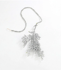 Detailed view of artificial silver glitter cypress leaf branches for Christmas decoration