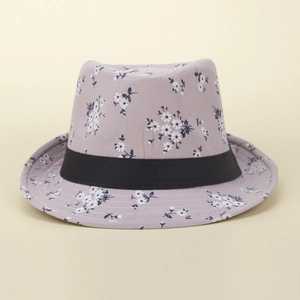 Detail showing lavender floral sun hat texture with white daisy print and black ribbon