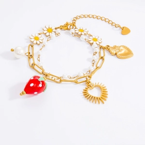 Detail of double-layer gold bracelet with strawberry, daisy, heart, and sun charms